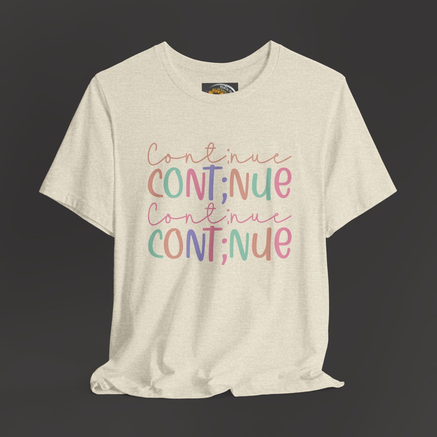 Continue Semicolon/Front View/ Hanging Mockup/ Heather Prism Natural  Color Tee Shirt